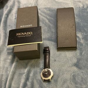 Men’s (unisex) Movado Black Watch with Minimalist Design Silver tone face. 35mm